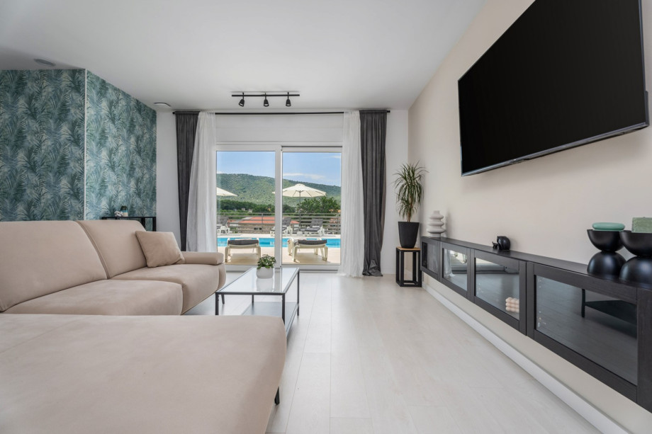 Living room and glass door toward the pool area.
