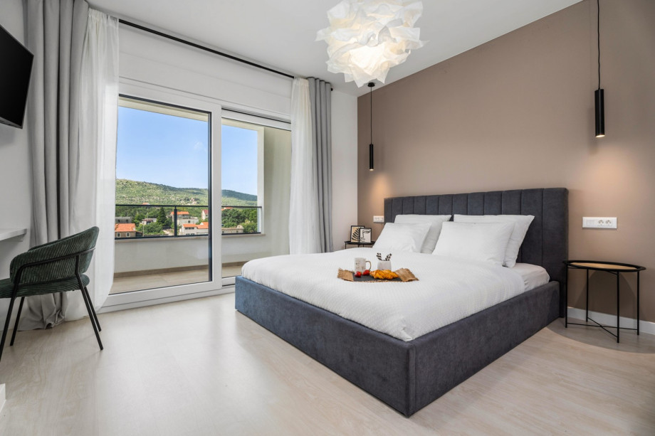 Bedroom NO1 with a TV, A/C, pool views, and en-suite bathroom.