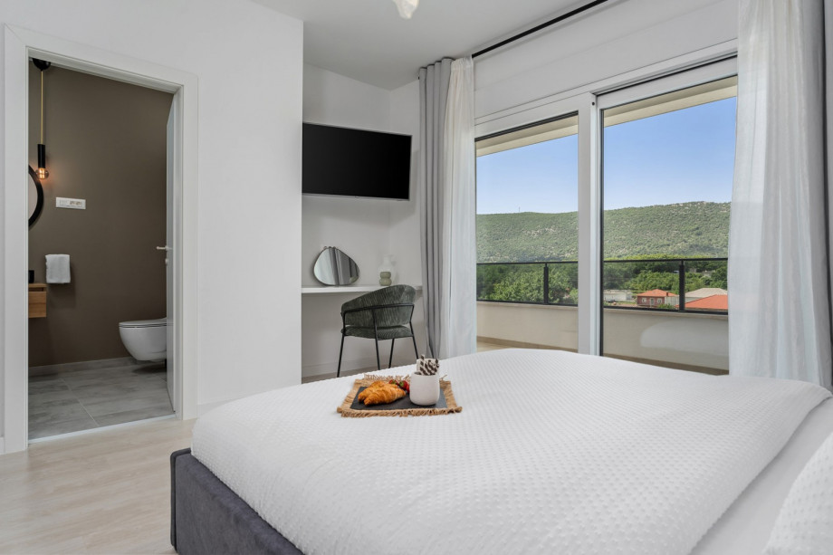 Bedroom NO1 with a TV, A/C, pool views.