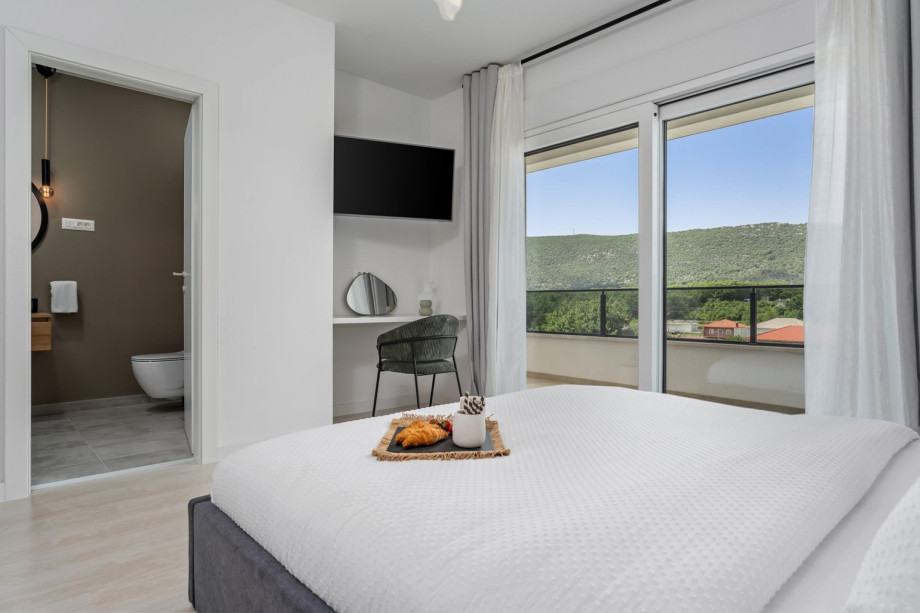 Bedroom NO1 with a TV, A/C, pool views.