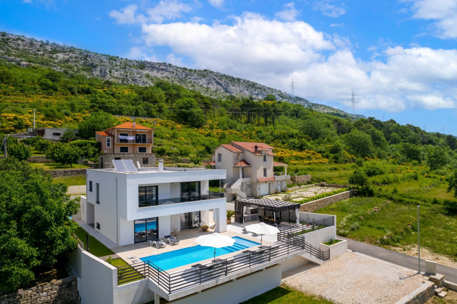 Private pool with a sun deck area, and a covered outdoor dining area.
