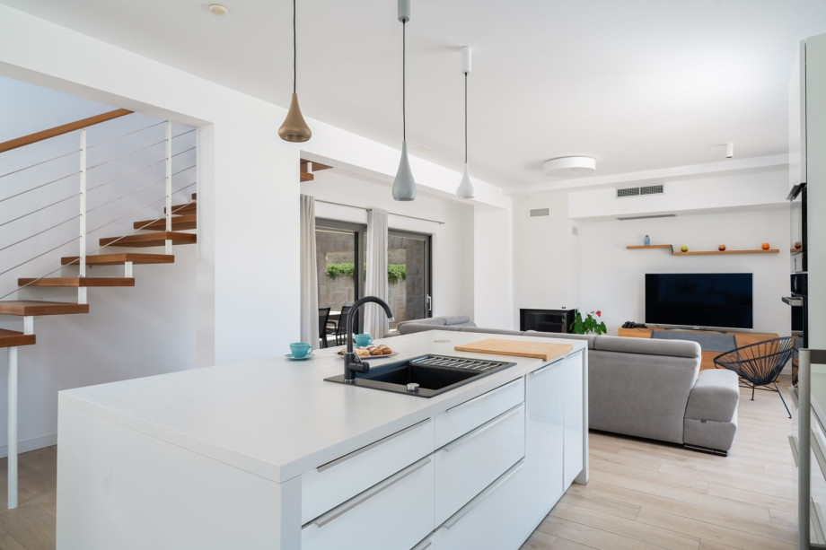 As you enter the ground floor, you're greeted by an expansive 60 sqm open-plan living area,