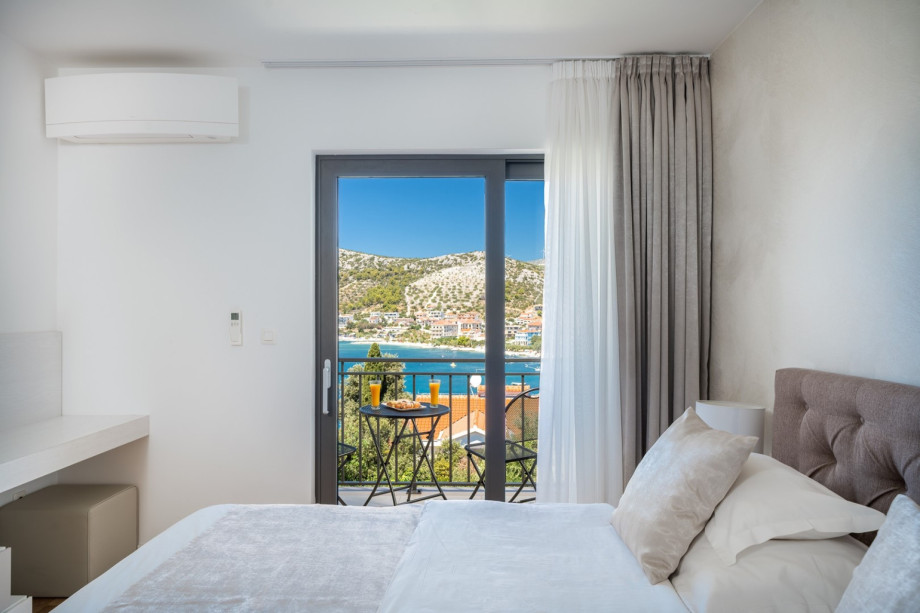 Bedroom No.2 also offers an en-suite bathroom, TV, air conditioning, and a balcony