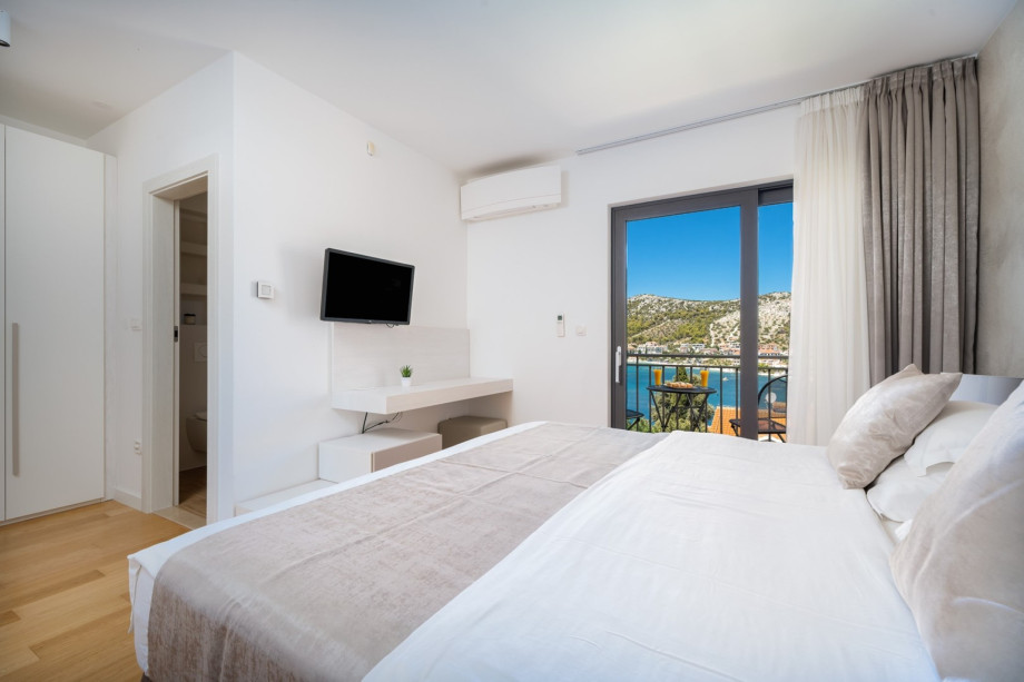 Bedroom No.2 also offers an en-suite bathroom, TV, air conditioning, and a balcony