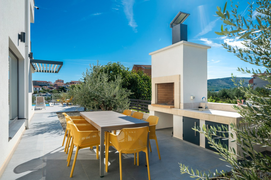 A barbecue area with a kitchen top and sink