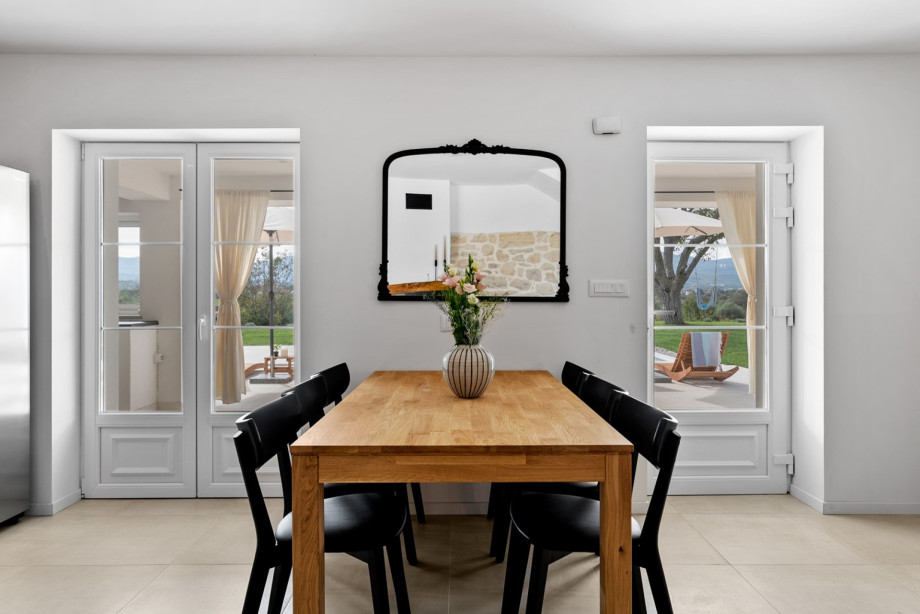 Comfortable dining area with an exit to the pool area