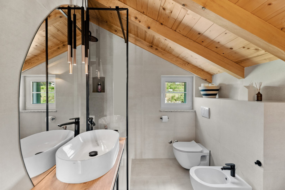 A family bathroom with a walk-in shower, toilet and a bidet