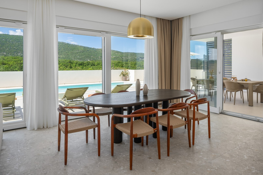 As you step inside, you are greeted by a seamless open-plan living, dining, and fully equipped kitchen area with a kitchen island