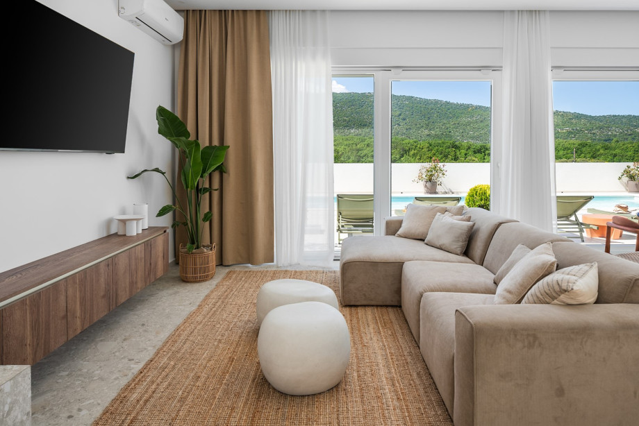 The living room and dining area are meticulously designed for relaxation and entertainment