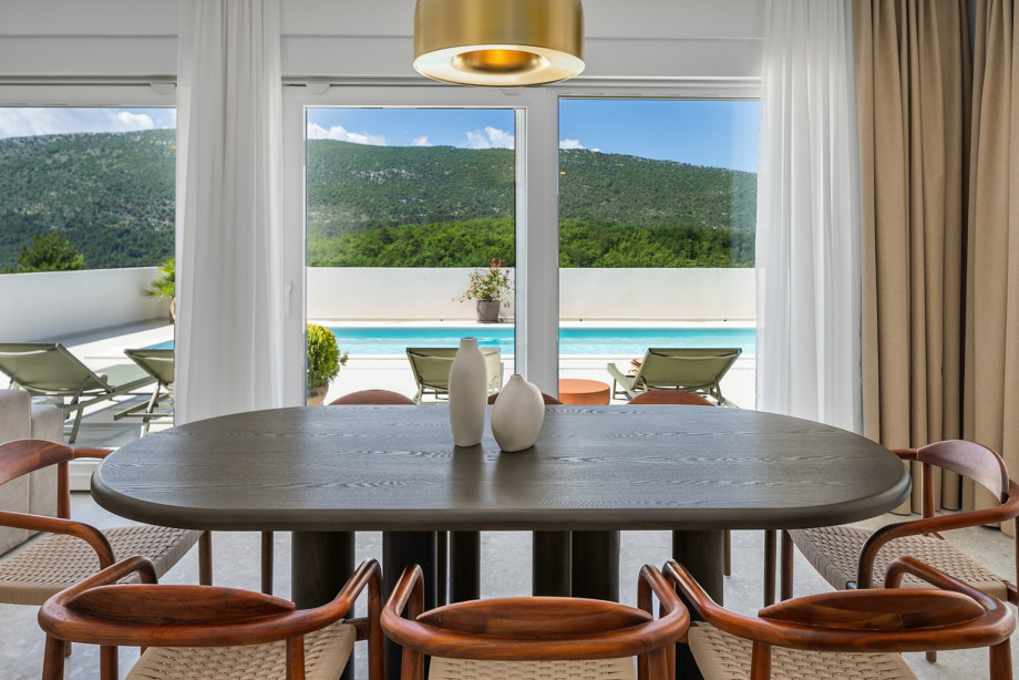 Comfortable dining area with an exit to the pool area