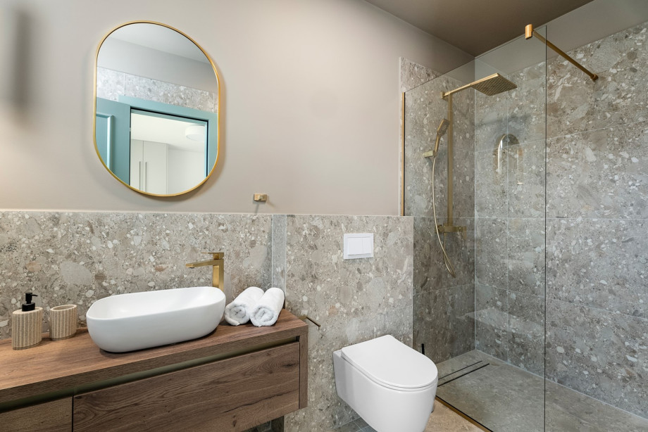 An en-suite bathroom with a shower, a sink, and a toilet