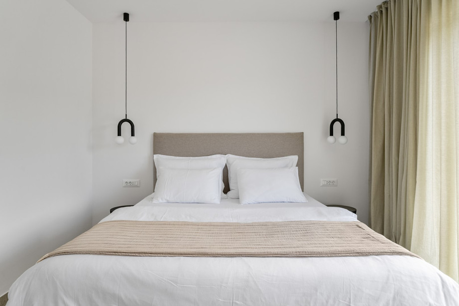 Bedroom No.2 also offers an en-suite bathroom, TV, air conditioning, and a balcony overlooking the serene pool