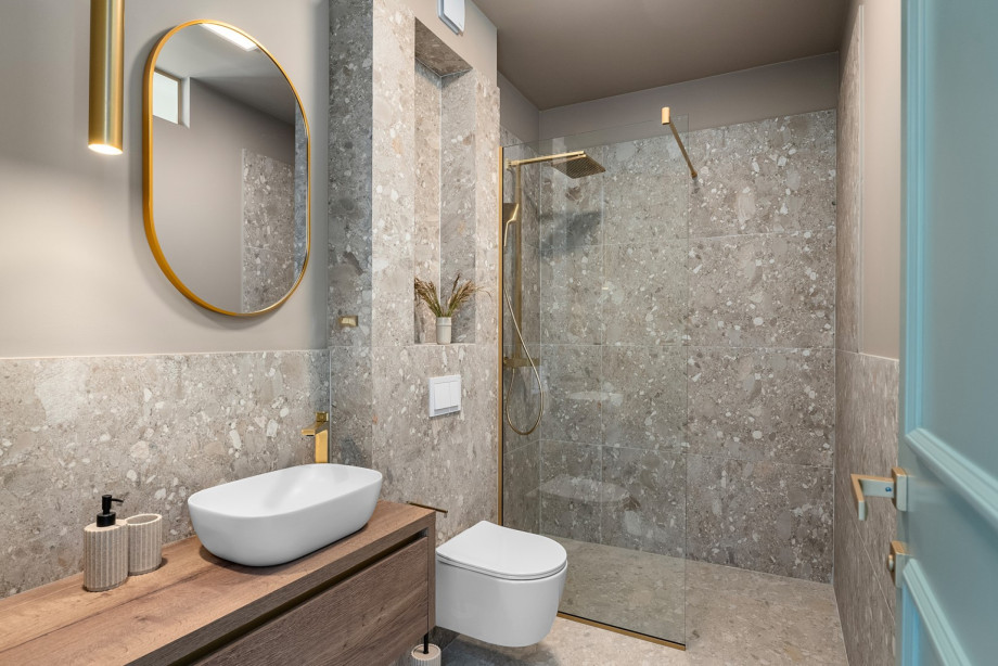 An en-suite bathroom with a shower, a sink, and a toilet