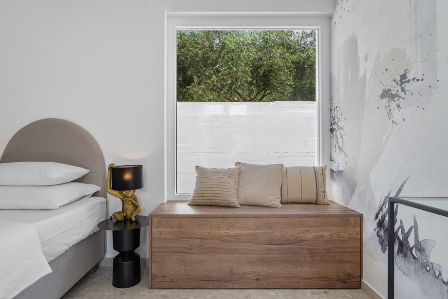 Bedroom No.3 also offers a TV, A/C, and a glass door opening to the lush artificial grass plot