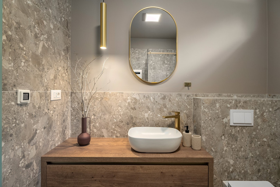 A family bathroom with a convenient shower, a washing machine, and a dryer