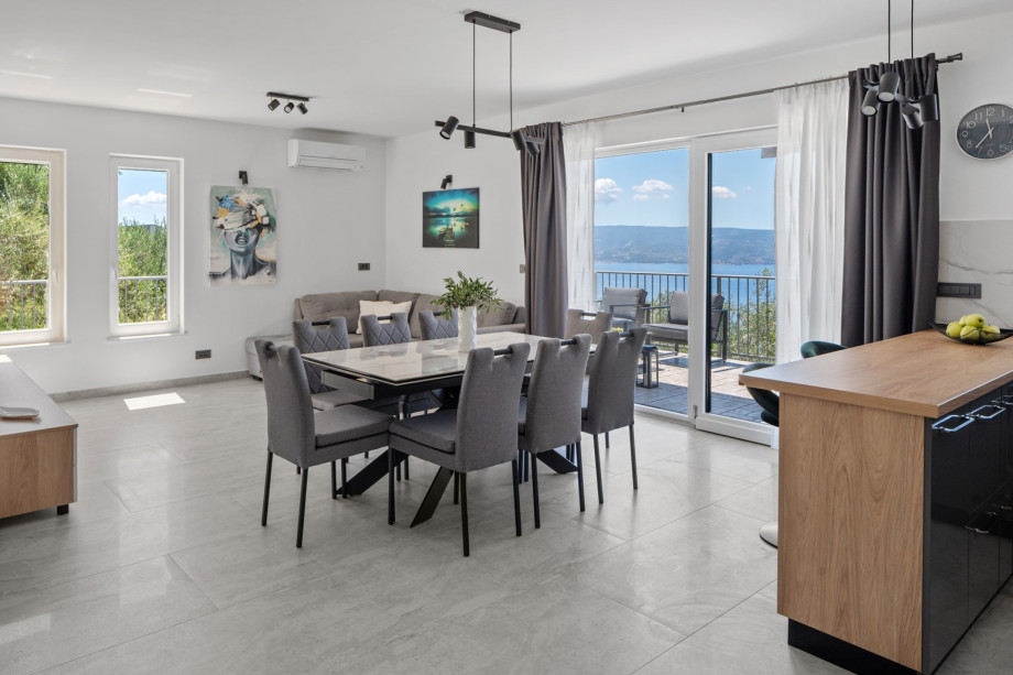 The ground floor features a stylish living and dining area with air conditioning