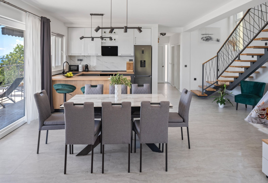 The ground floor features a stylish living and dining area with air conditioning