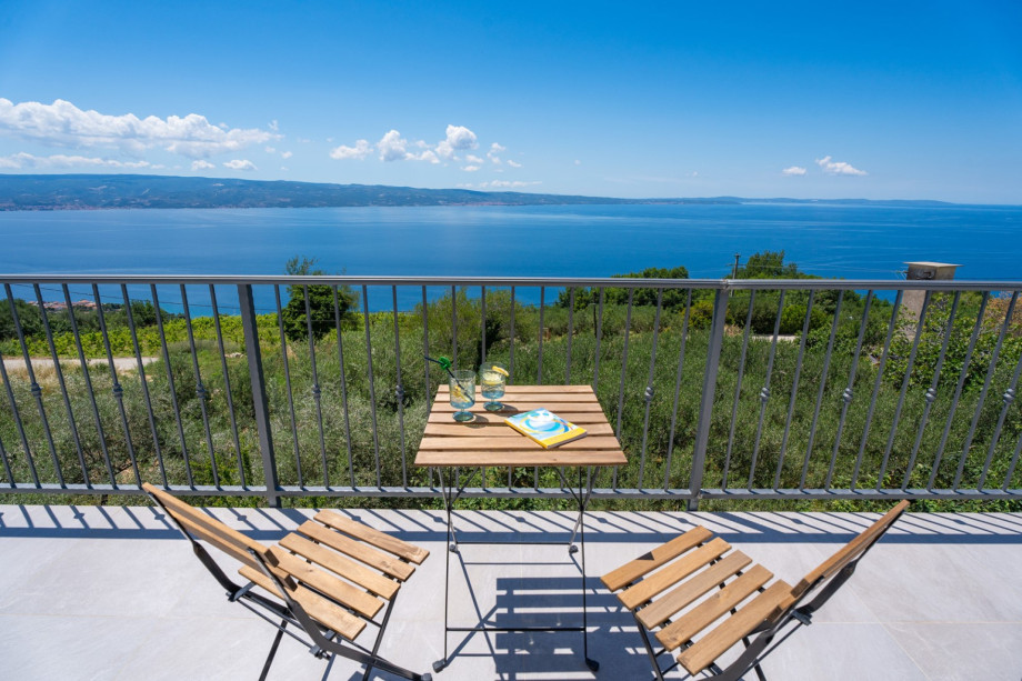 A balcony in front of the bedrooms on the first floor.