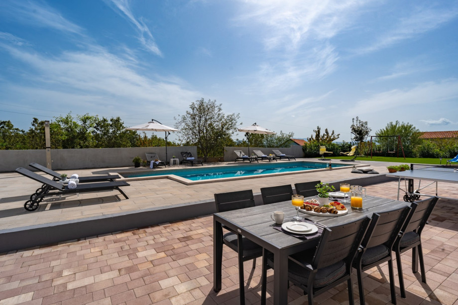 Spacious sun deck area with dining table