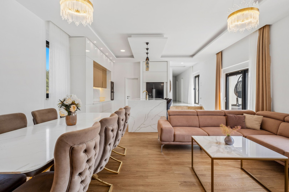 Living room and dining area with exit to sun deck and pool, all air - conditioned