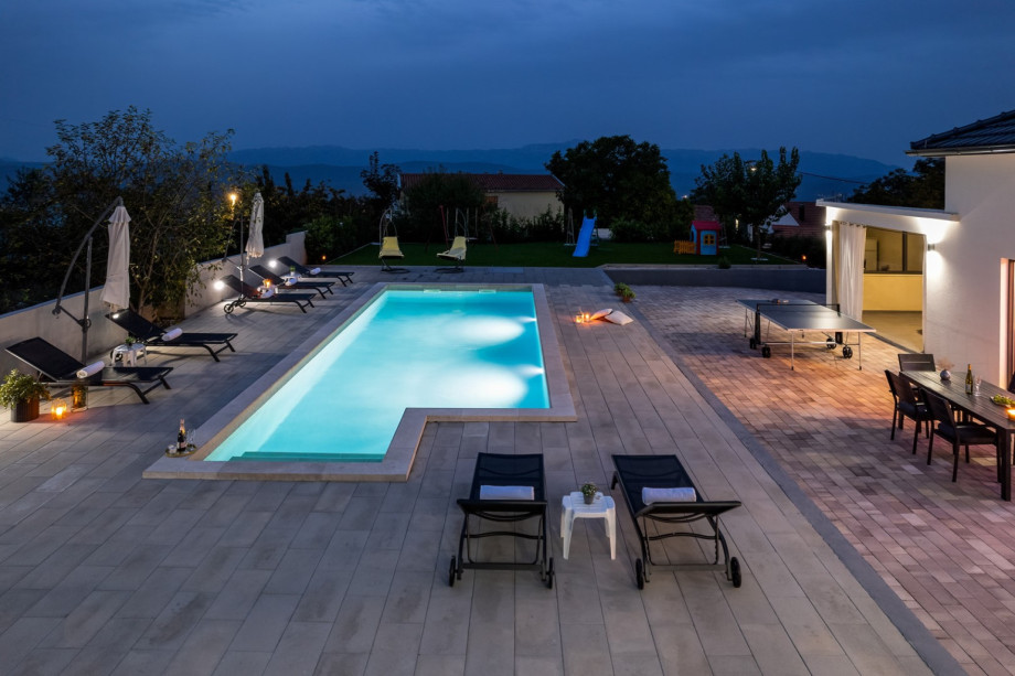 Outdoor area with summer kitchen and dining area