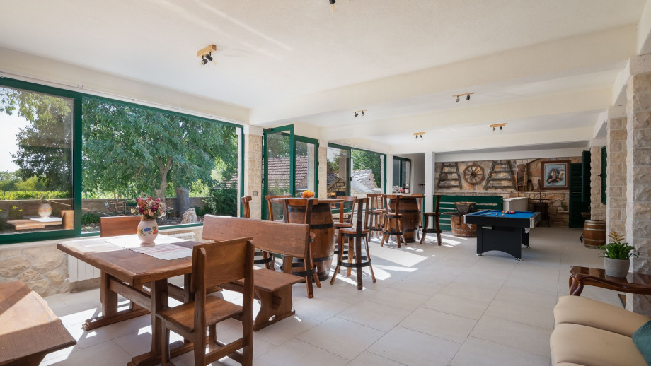 Spacious, glazed terrace with Billiards, Darts, a wooden dining table and two handmade wooden bar tables