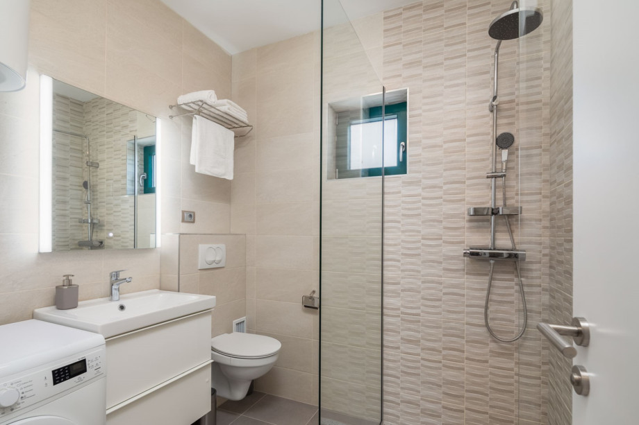 Family Bathroom NO4 with a shower and a washing machine