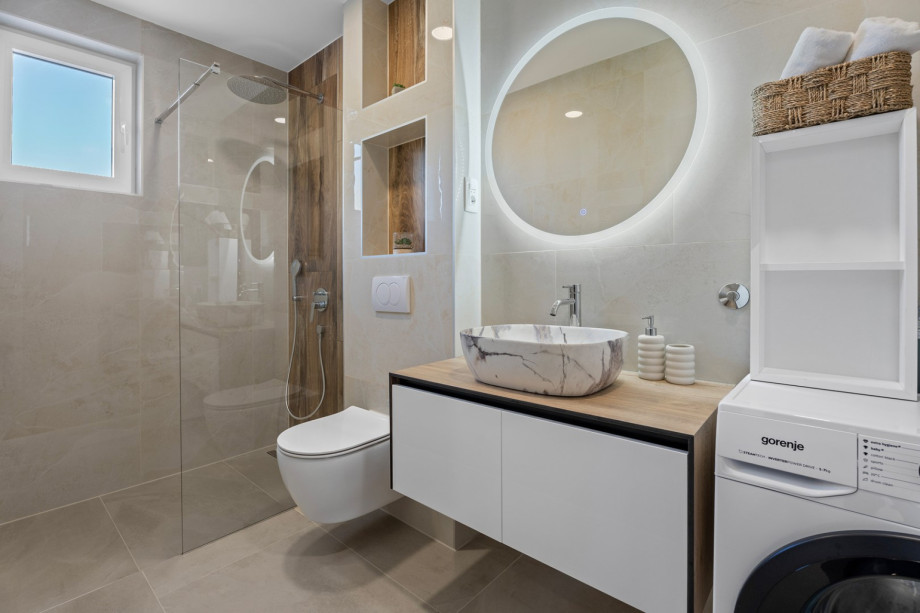 Family bathroom with a shower and a washing machine