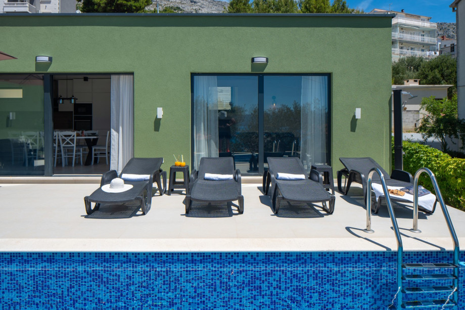 Surrounded by swaying olive trees, the outdoor area with a barbecue