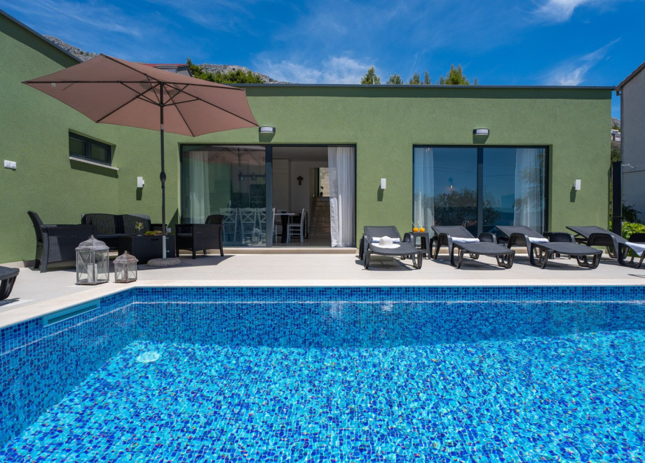 Spacious sun deck area with deck chairs, sun umbrellas