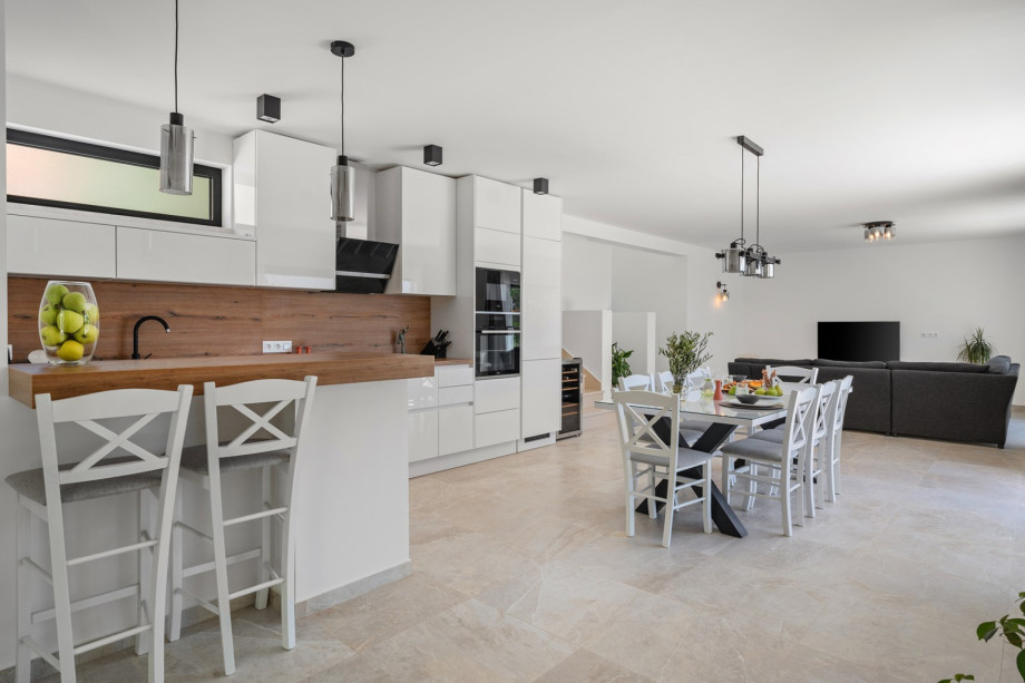 Living room, dining area, and kitchen are all connected by an open-plan layout