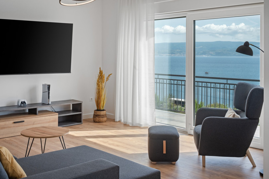 Living room, dining area, and kitchen are all connected by an open-plan layout