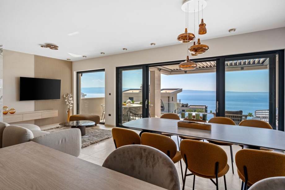 Living area with direct exit to covered outdoor dining area and pool