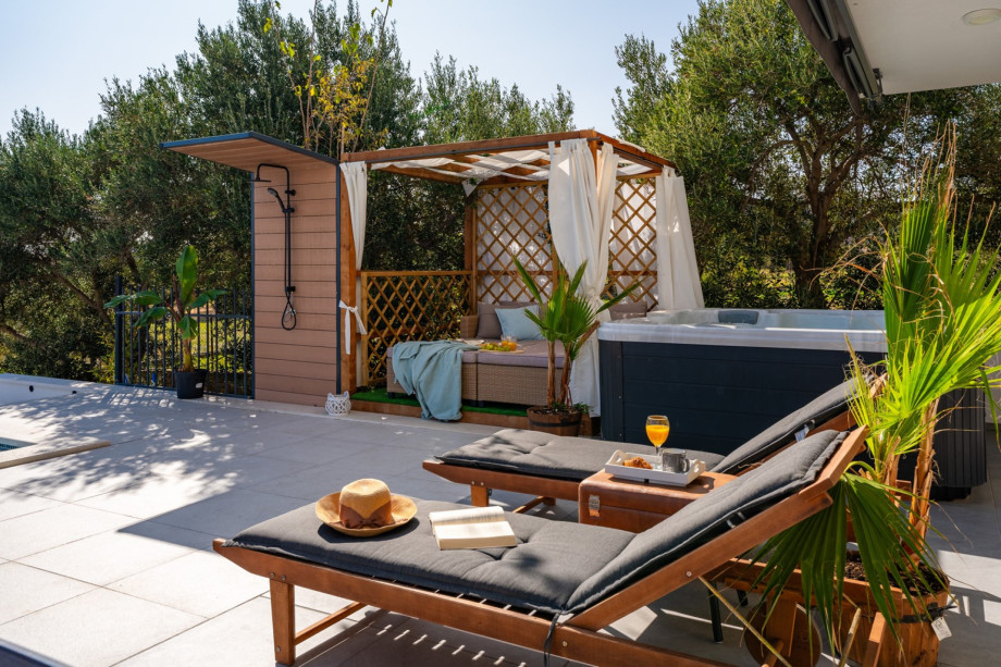 Comfortable lounge corner next to a hot - tub