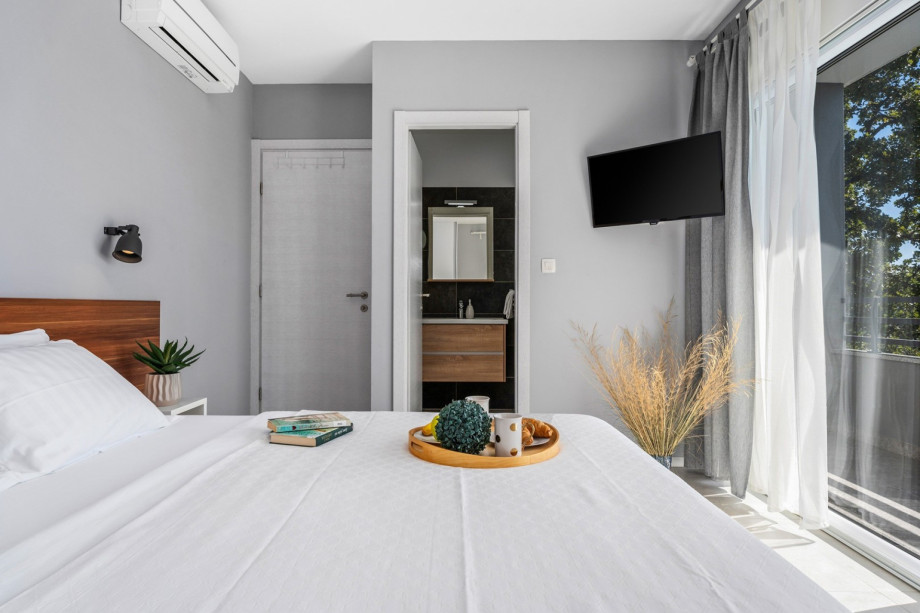 Bedroom NO3 with exit to a partially covered terrace with a lounge corner and panoramic views of town Split