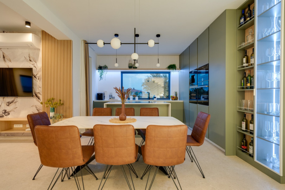 A fireplace, a direct exit to the outdoor dining area and pool