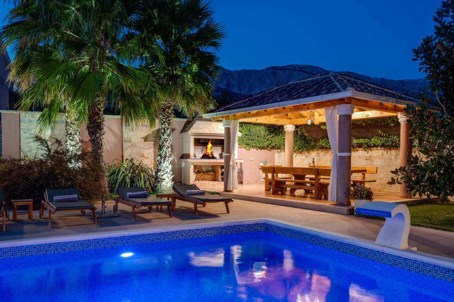 covered outdoor dining area with barbecue