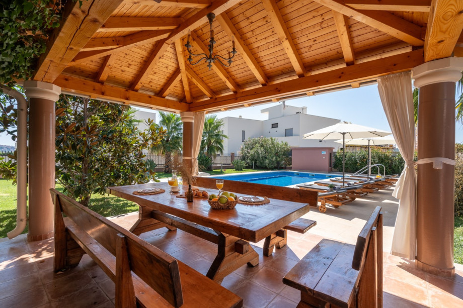 covered outdoor dining area with barbecue