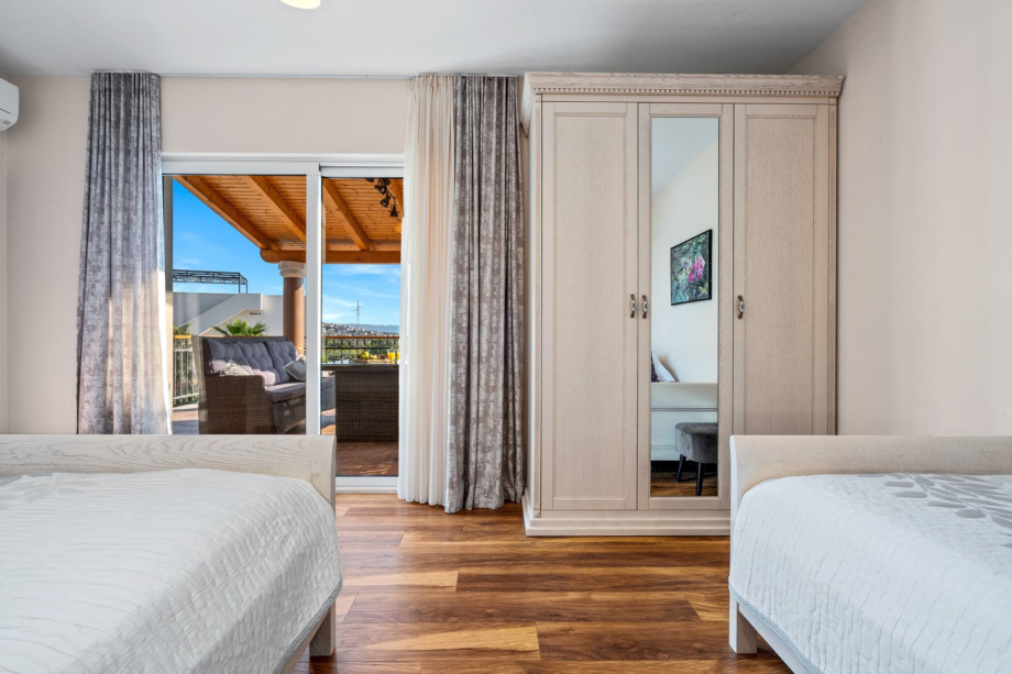 Bedroom No2 with king size bed 180cm x 200cm and a single bed 90cm x 200cm, A/C and exit to the terrace with lounge furniture