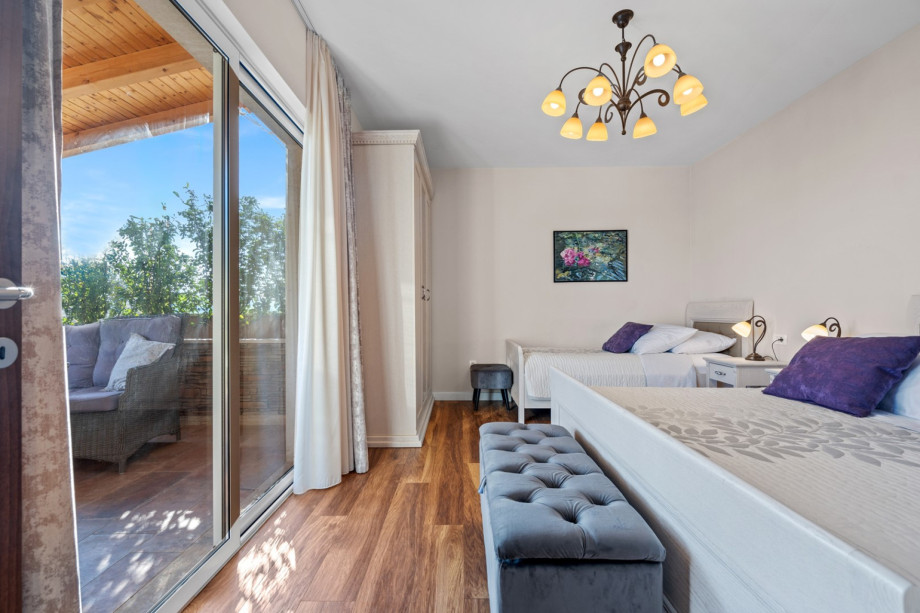 Bedroom No2 with king size bed 180cm x 200cm and a single bed 90cm x 200cm, A/C and exit to the terrace with lounge furniture