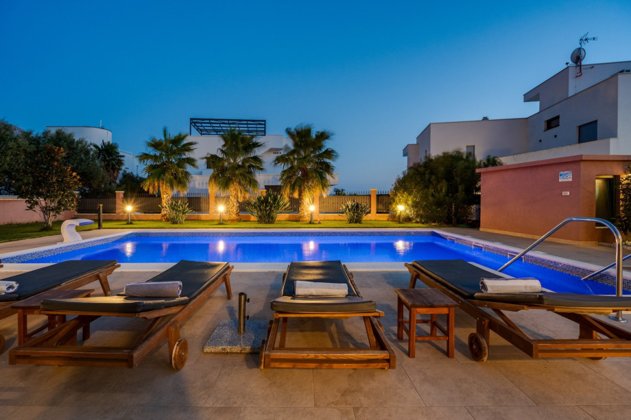 a private, heated 10m x 5m pool with massage system, 6 deck chairs and 2 parasols