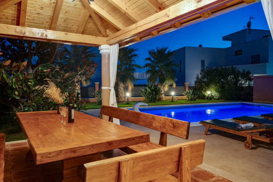 covered outdoor dining area with barbecue