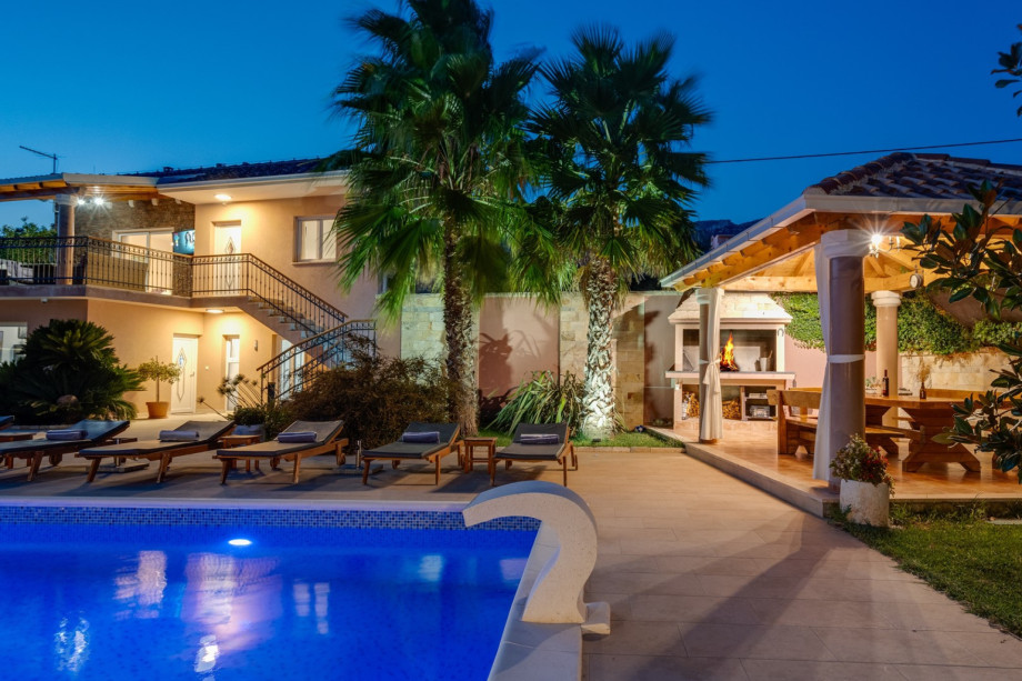 covered outdoor dining area with barbecue