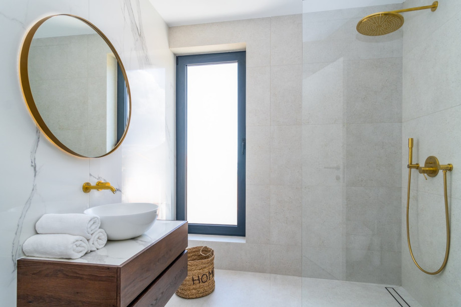 An en-suite bathroom with a shower, a sink, and a toilet