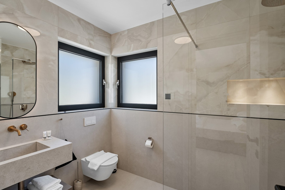 Private bathroom with a shower, towels are provided