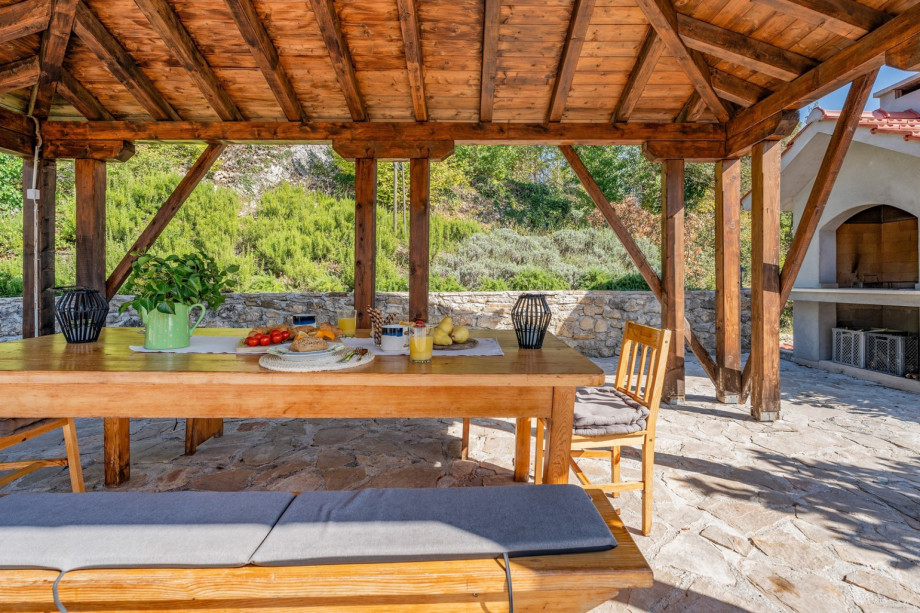 Covered outdoor dining area and traditional barbecue
