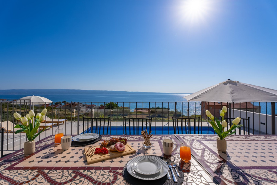 Covered outdoor dining area (a few steps above the pool and sundeck).