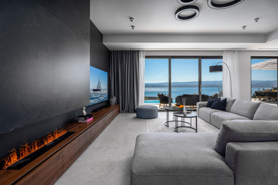 Modern furnished living area with exit to the pool.