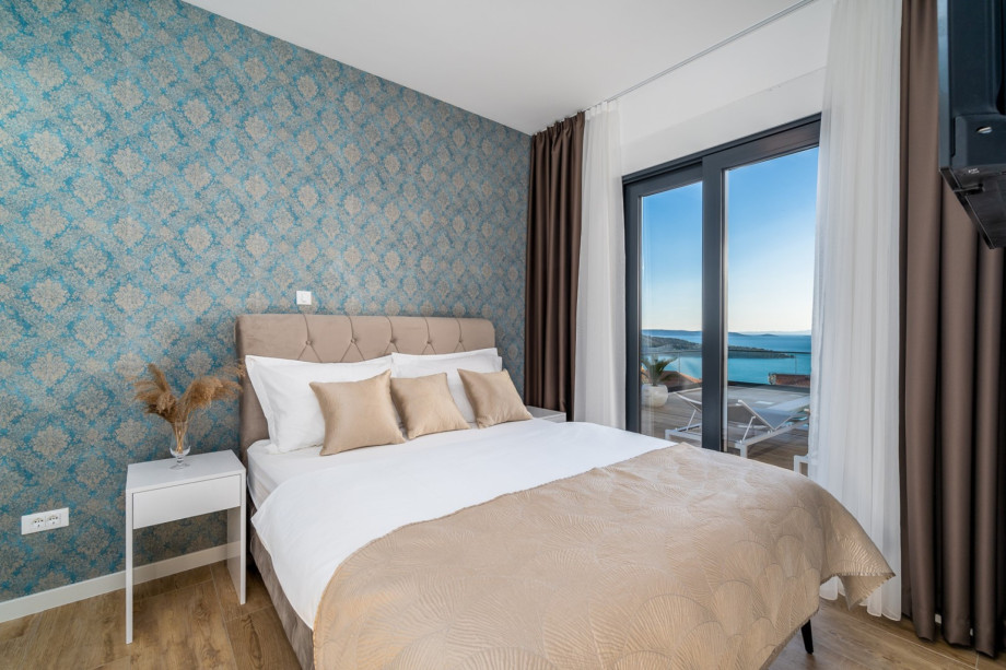 A Bedroom No1 (South) with a double bed 160cm x 200cm, A/C, a TV, and a direct exit to the pool area.