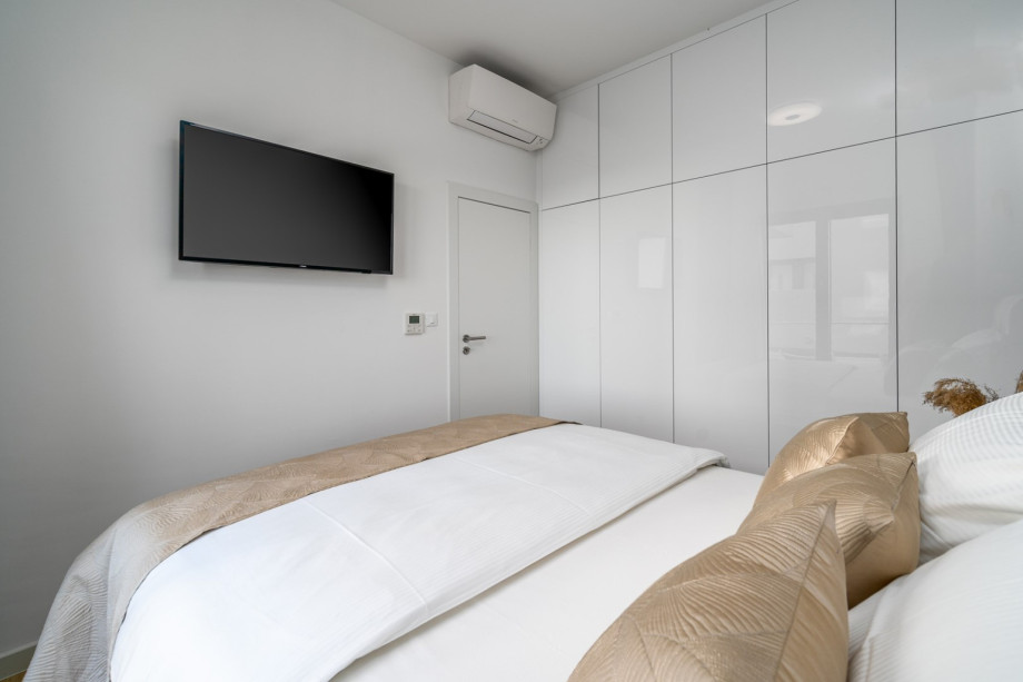 A Bedroom No1 (South) with a double bed 160cm x 200cm, A/C, a TV.